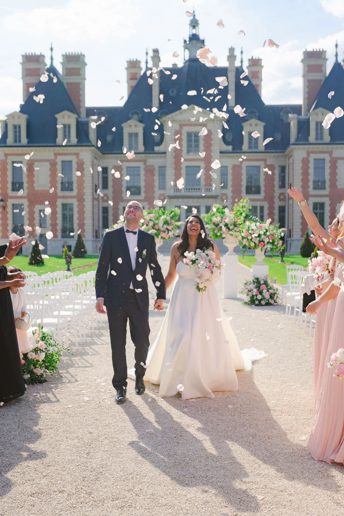 A&P Wedding couple celebrating beneath falling flower petals