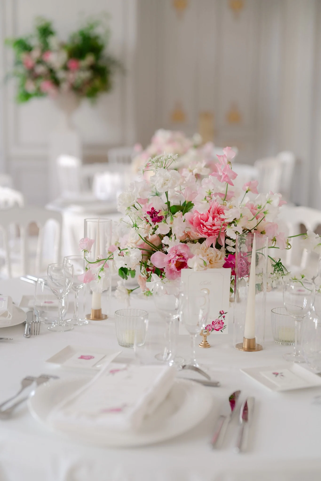 Soft pink and white flowers on a wedding reception table
