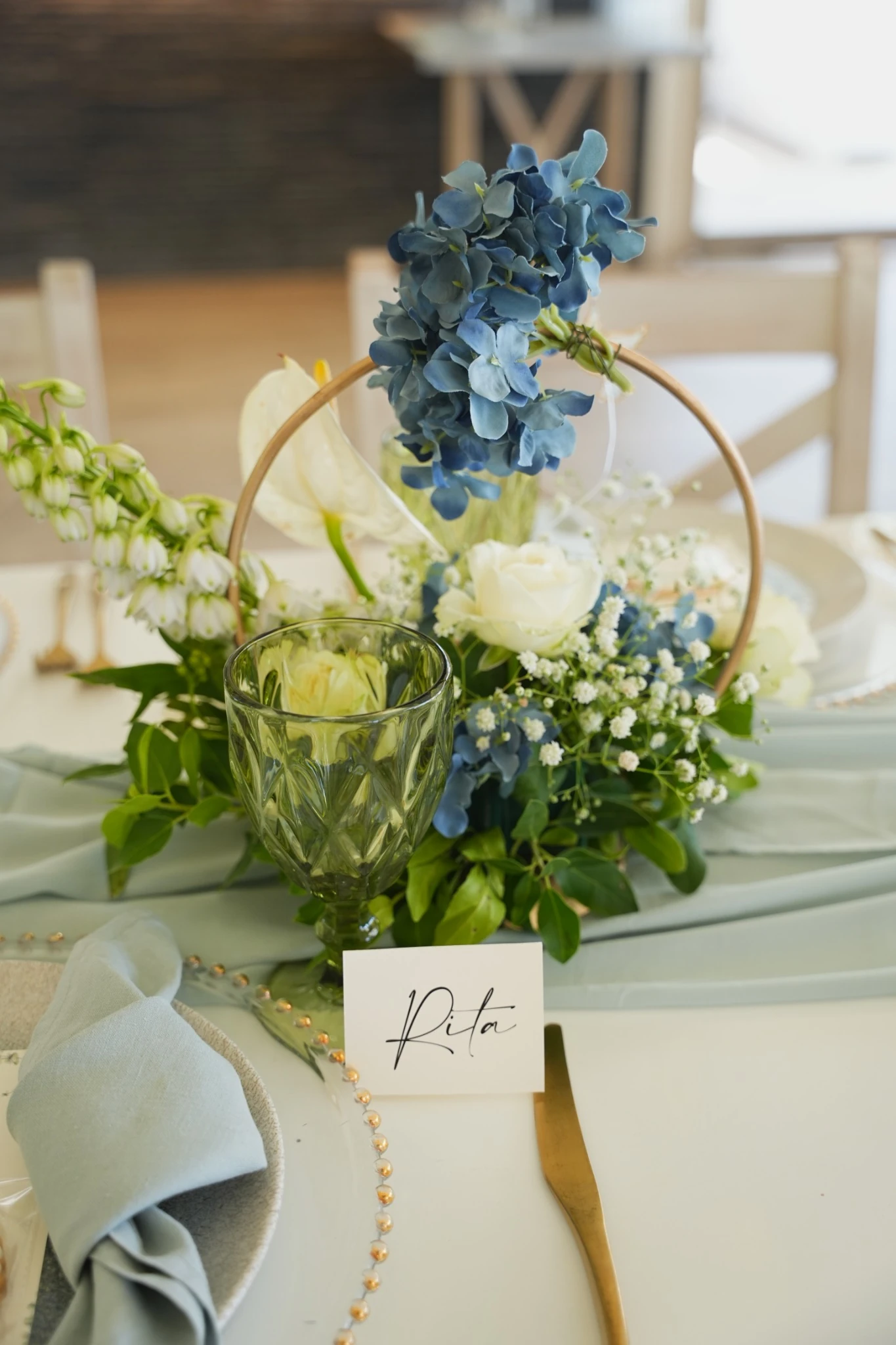Blue and ivory floral centerpiece with an individual guest place card