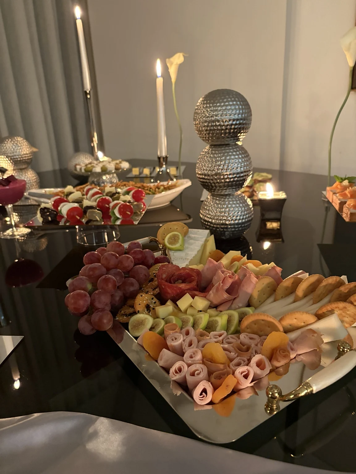Metallic sphere sculpture with candles and artisanal food styling