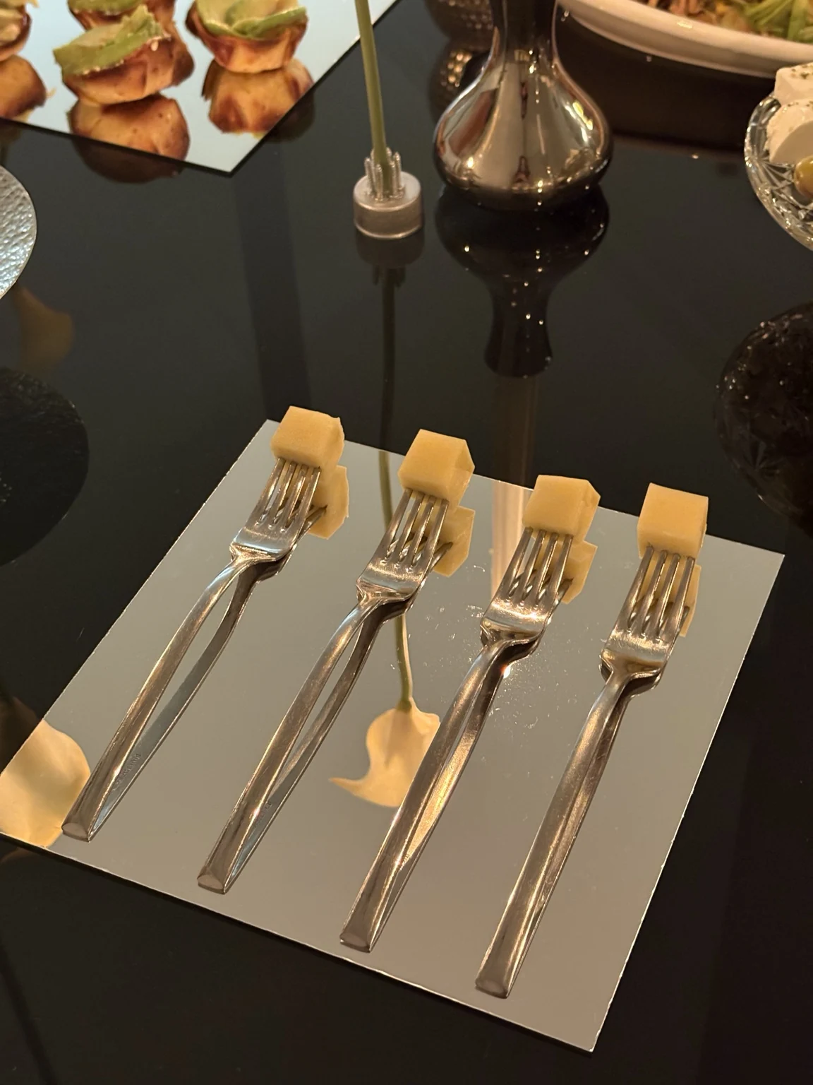 Buffet table details with fresh bites and polished reflective surface