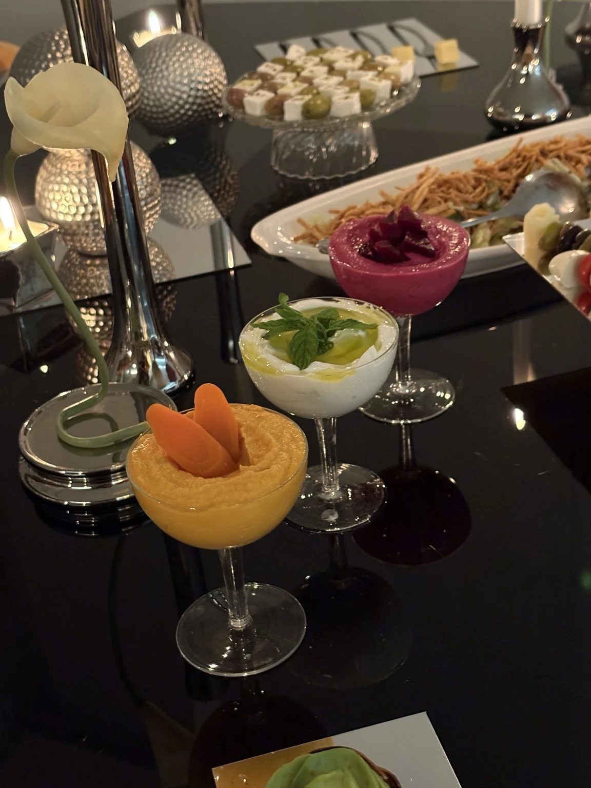 Minimalist bite-sized cheese presentation on a mirrored tray